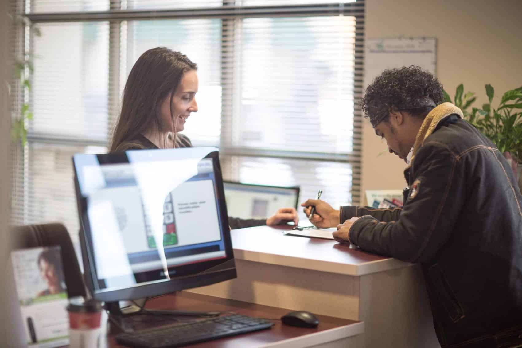 Photo of a patient filling out forms at Weig Chiropractic Center